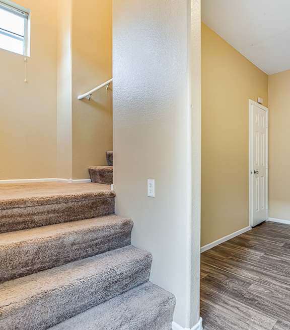 A room with a staircase leading to the second floor.