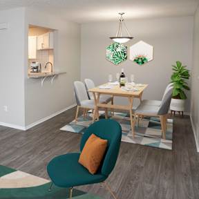 A modern living room with a dining area and kitchen in the background.