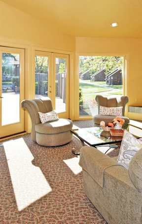 A living room with orange walls and furniture.