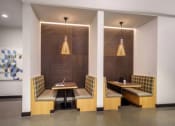 Thumbnail 15 of 24 - a room with two tables and two chairs and a painting on the wall at NoMa Apartments, California, 94596