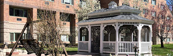 a white gazebo in front of a building