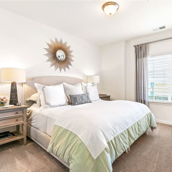 a bedroom with a large bed and a window