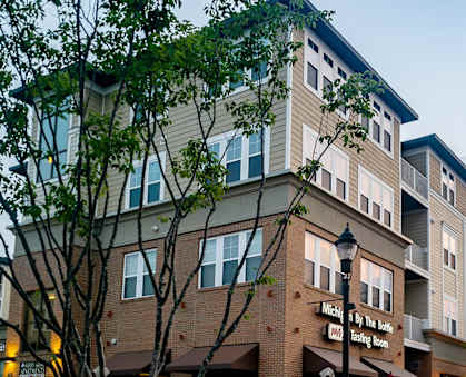 a city street with cars parked in front of a building