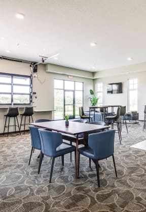 a communityroom with a table and chairs