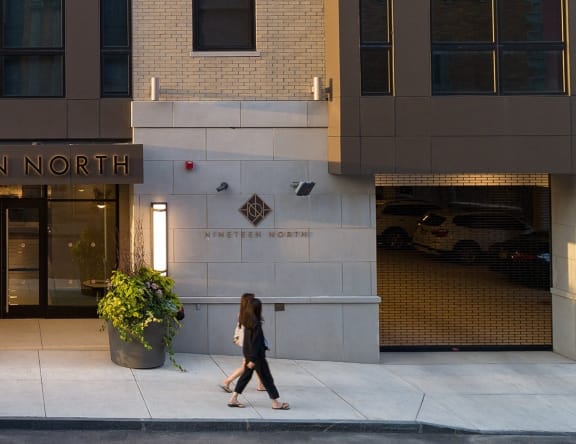 a woman walks past the entrance to the ninfenner mortimer building at Nineteen North, Buffalo, New York