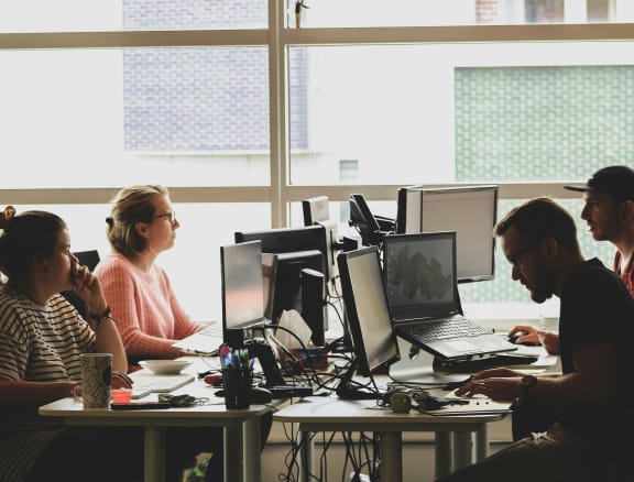 people working on computers in an office