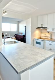 a kitchen with white cabinets and white appliances