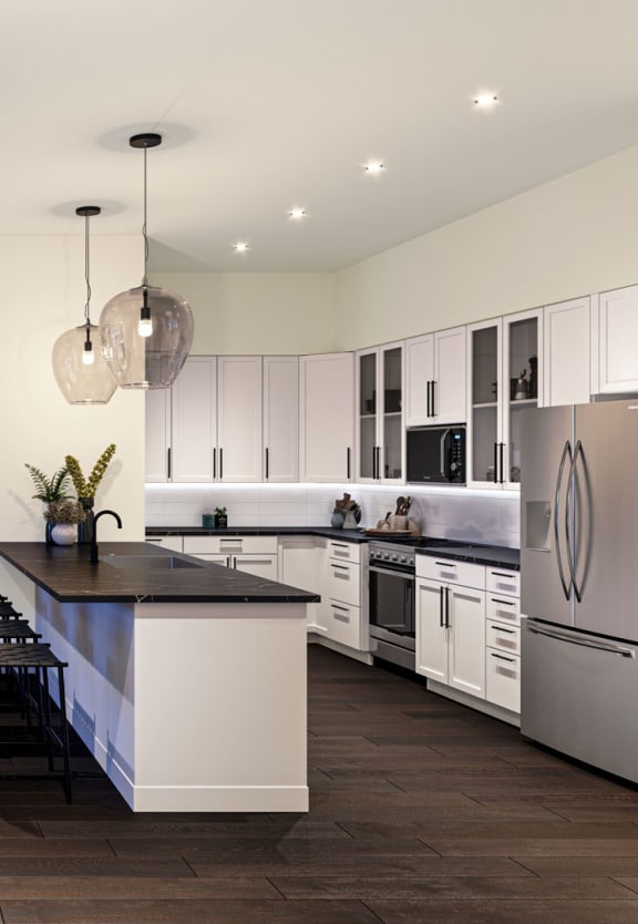 a rendering of a living room with a kitchen and dining area at The Willard Apartments, Owings Mills Maryland