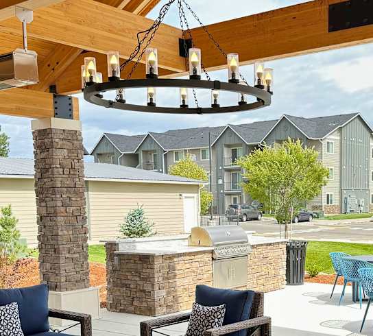 A patio with blue cushions and furniture.