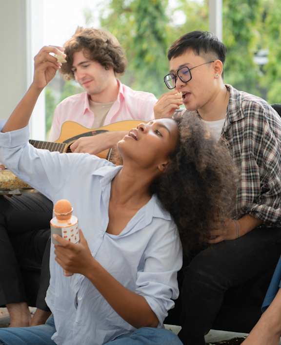 a group of people are sitting on a couch and talking at Icon One, Florida, 32114