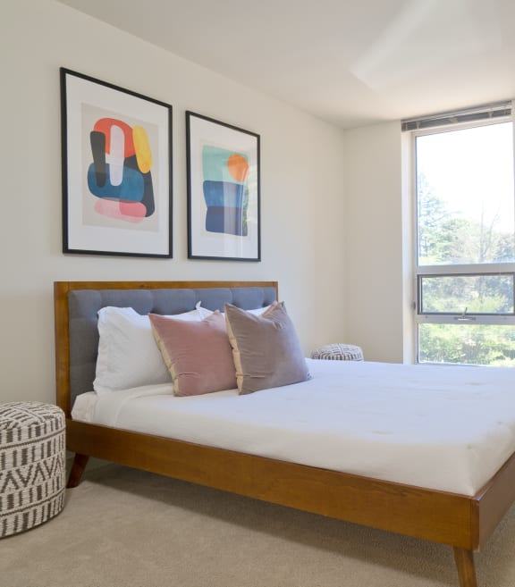 a bedroom with a bed and a dresser and a window