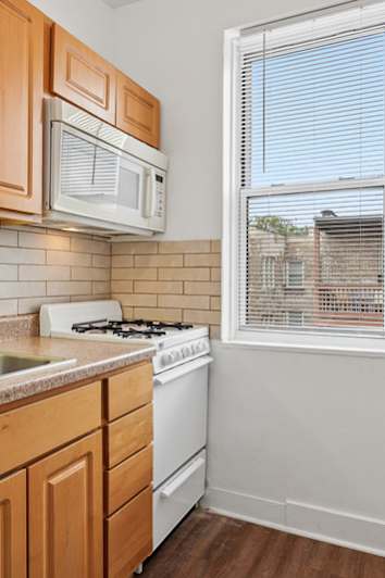 Kitchen with wooden cabinets and a window