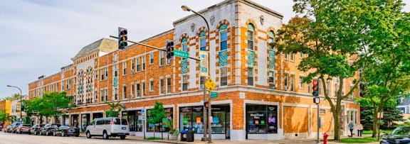a large brick building on the corner of a city street