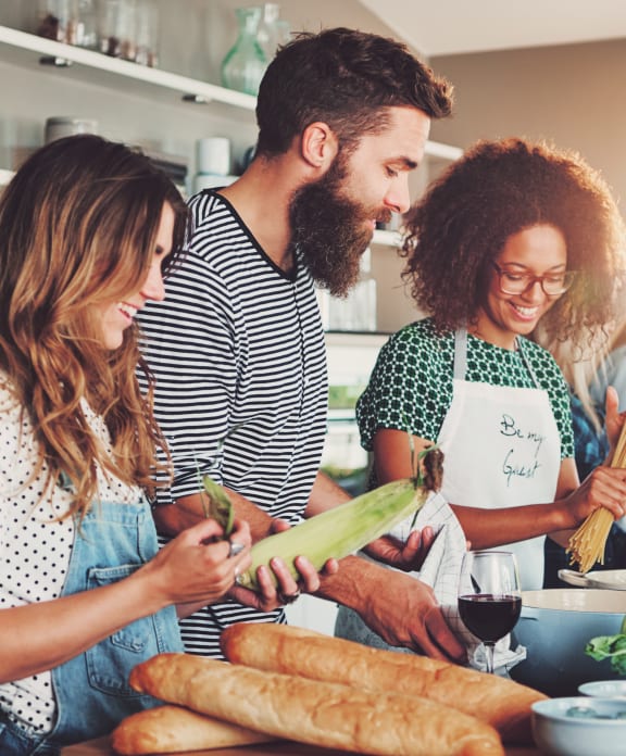a group of people in a kitchen preparing food