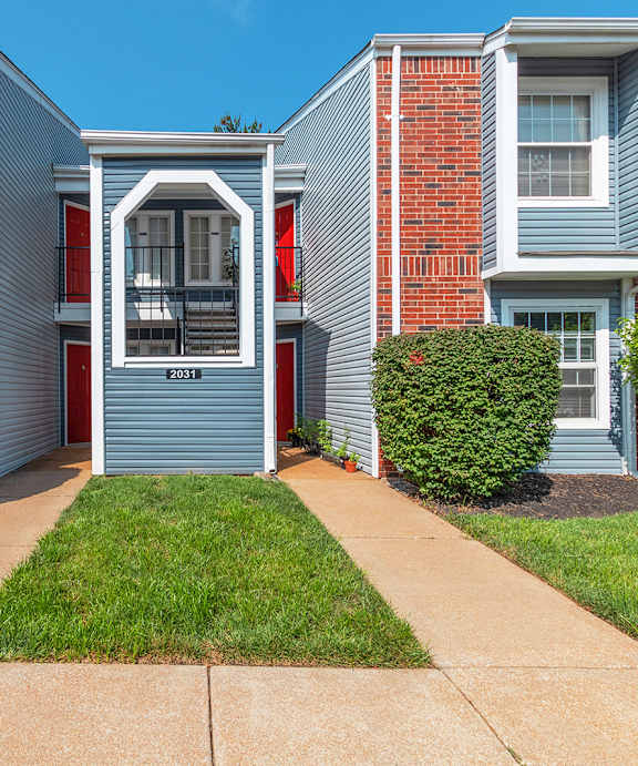 Exterior Breeze Way With Brick & Blue Exteriors