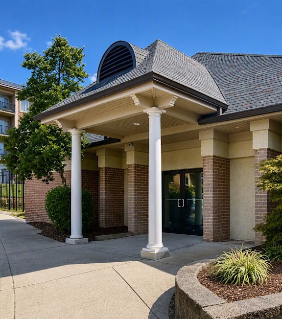A building with a grey roof and white columns.