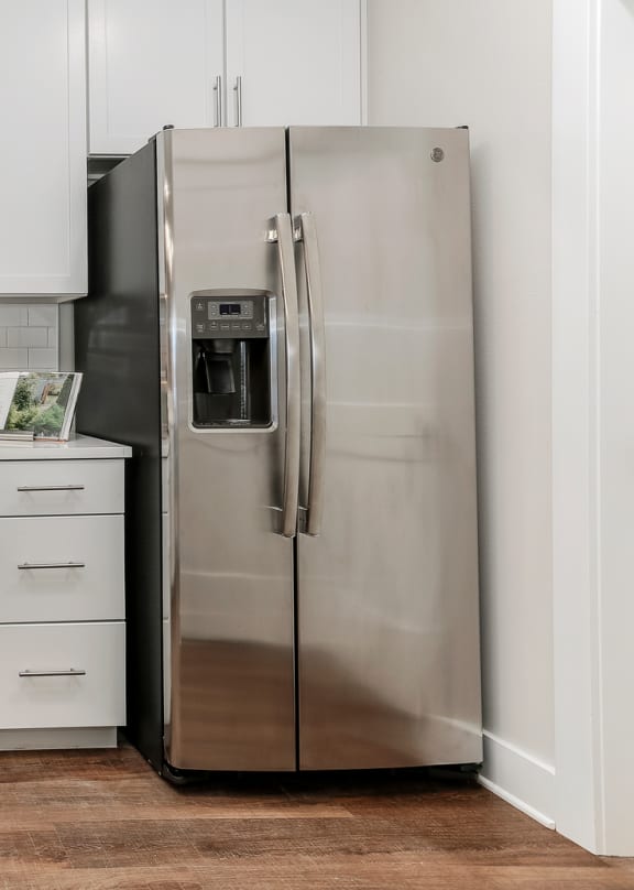 a white kitchen with stainless steel appliances and white cabinets at Annandale Apartment Homes, Tennessee 37128