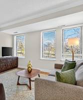 A living room with a brown couch, a wooden coffee table, and a flat screen TV.
