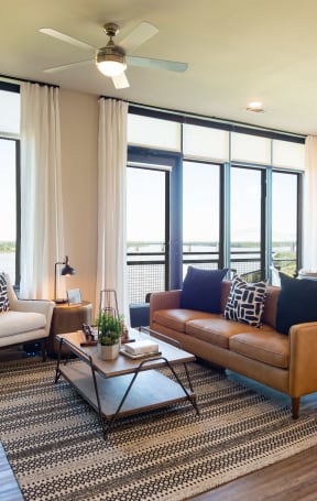 a living room and kitchen with a blue couch and a table