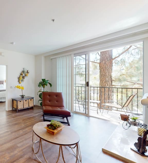 a living room with a blue couch and a patio door  at L'Estancia, Studio City, CA, 91604