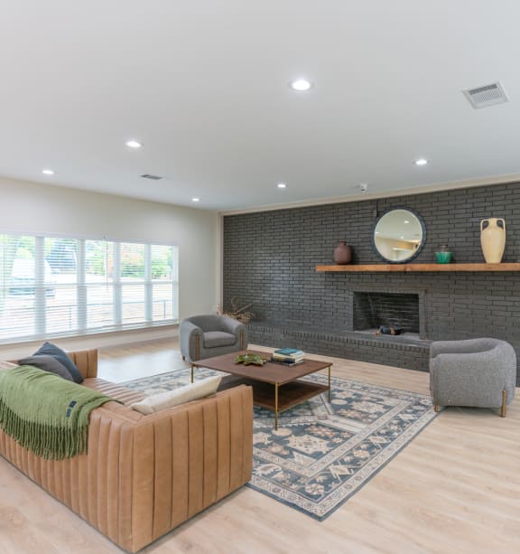 a living room with a couch and chairs and a fireplace
