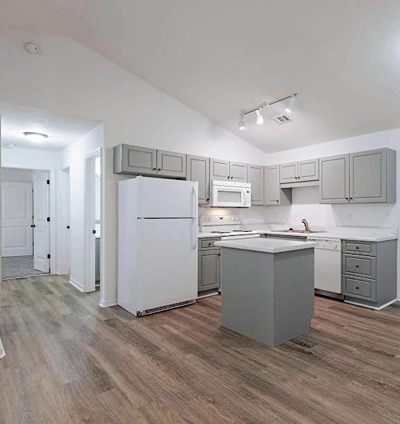 an open kitchen and dining area with a marble counter top at Sterlington Apartments, Grovetown, GA, 30813