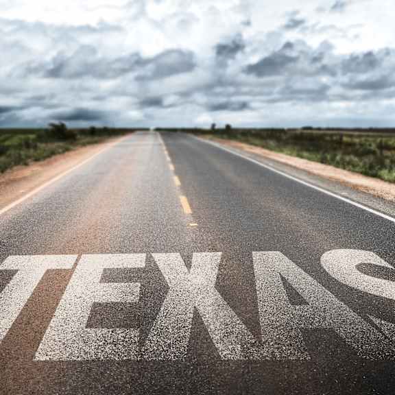 A road with the word TEXAS painted on it.