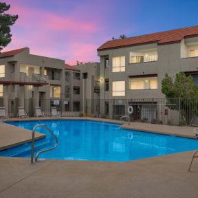 a swimming pool at night in front of an apartment building at Glen Brae, Glendale, AZ, 85301