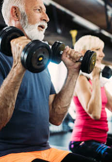 Two people lifting dumbbells