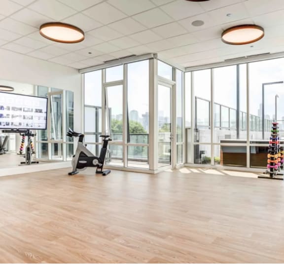 Spacious Fitness Studio with Plank Flooring and Floor to Ceiling Windows at North+Vine in Chicago Il