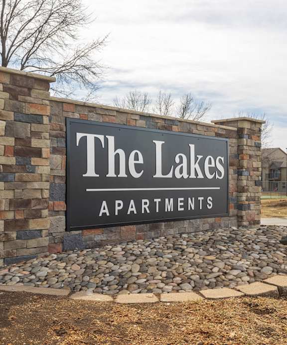 Entrance signage for The Lakes Apartments community at the main drive.