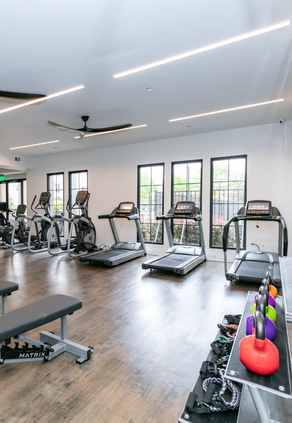 a row of treadmills in a gym at Emblem Alpharetta, Alpharetta, GA