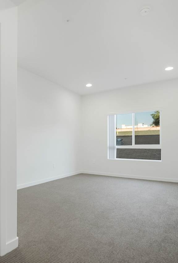 A modern living room with a large couch, a chair, a coffee table, and a television at Valley Street Apartment, Los Angeles, CA, 90057