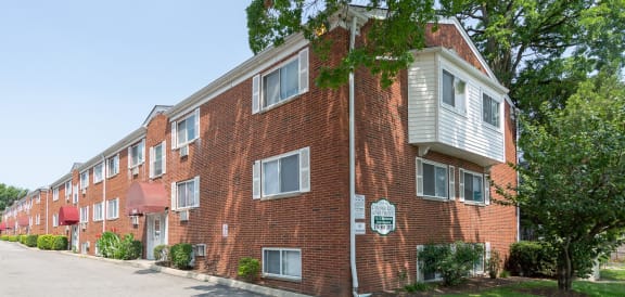 a brick apartment building with a street in front of it