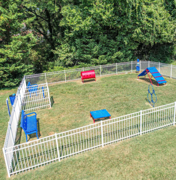 a fenced in backyard with a play area for dogs at Ashbrook Village, Gastonia, NC, 28054