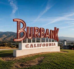 A large sign that says Burbank California in front of a mountain.