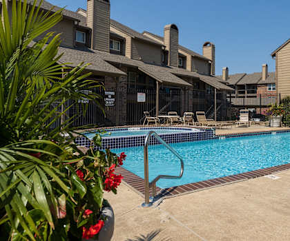 A sparkling pool with lounge chairs and umbrellas for a relaxing afternoon.