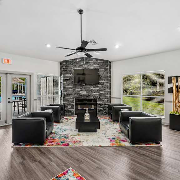 A living room with a fireplace and a rug.