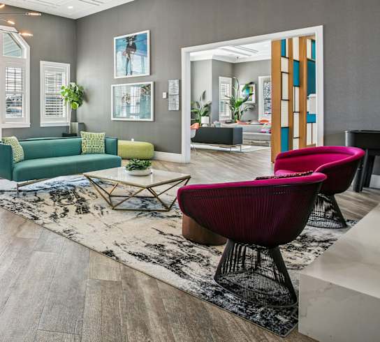 A living room with a giraffe statue in the middle.