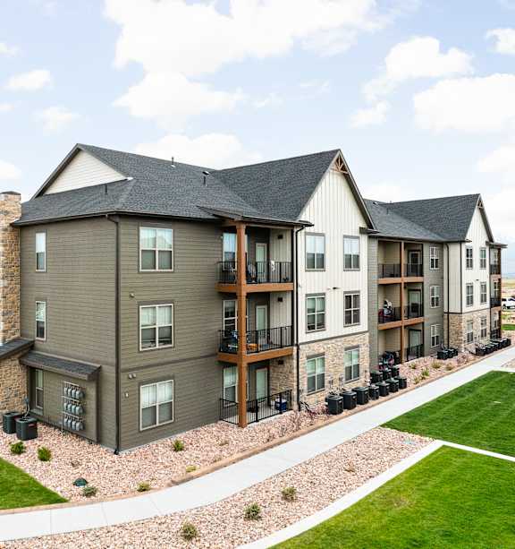 an aerial view of an apartment building with green grass and a parking lot at Apex, Colorado Springs, CO, Colorado, 80923