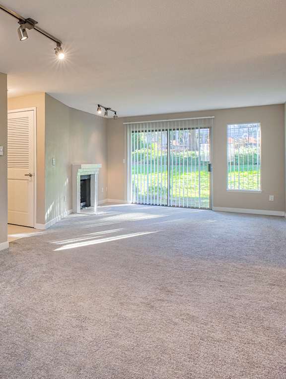 A kitchen with white appliances and wooden floors.