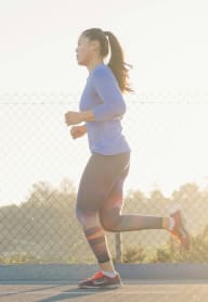 a woman running on a tennis court at sunset at Gordon Manor, Pomona, CA 91768