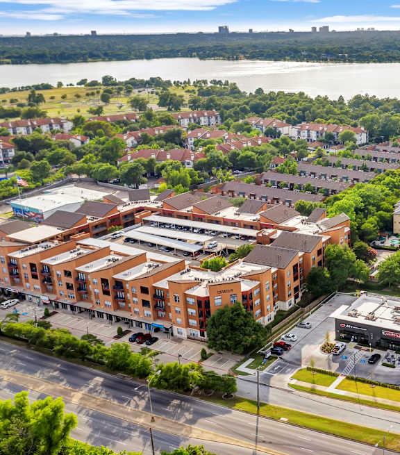 A view of a city with a river in the background and a parking lot in the foreground.