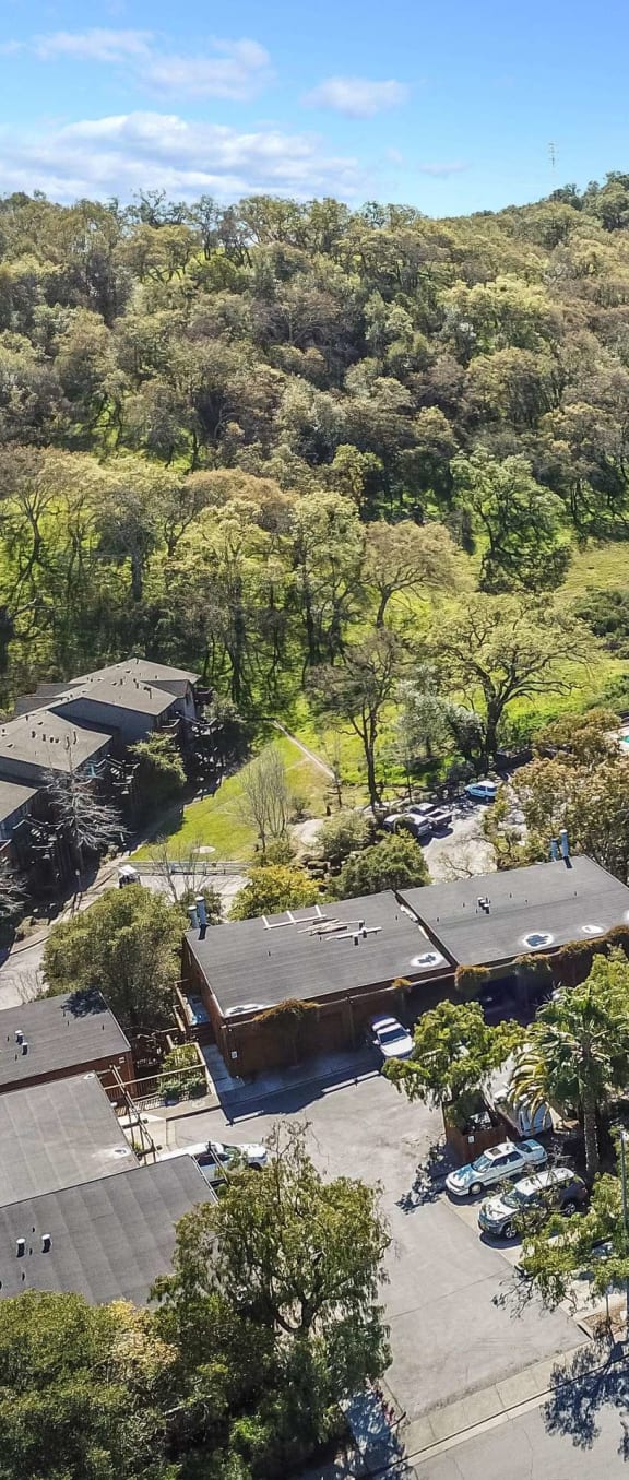 aerial view of apartment buildings and hillside