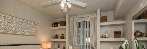 a bedroom with a large bed and a ceiling fan