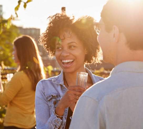 a group of people talking and laughing at a partyat First Street Lofts in Downtown Bismarck, Bismarck, 58506