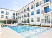 Thumbnail 4 of 28 - Modern swimming pool with lounge at The Maven, Suwanee, GA