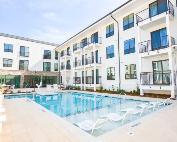 Modern swimming pool with lounge at The Maven, Suwanee, GA