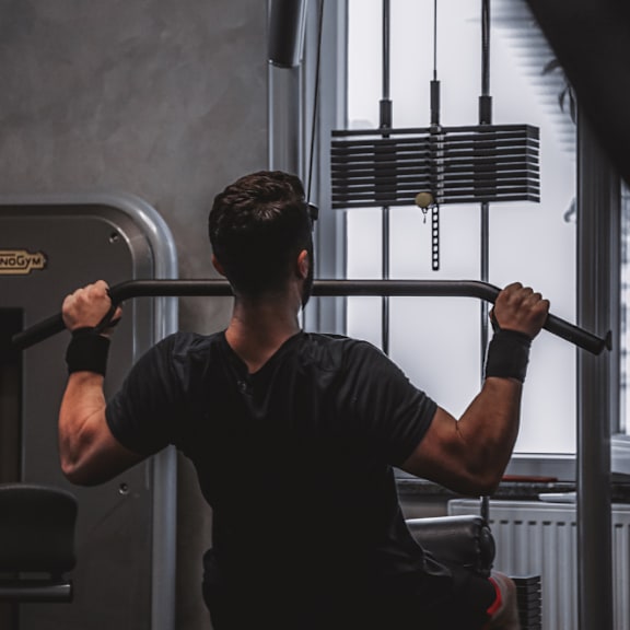 A man is working out in a gym.