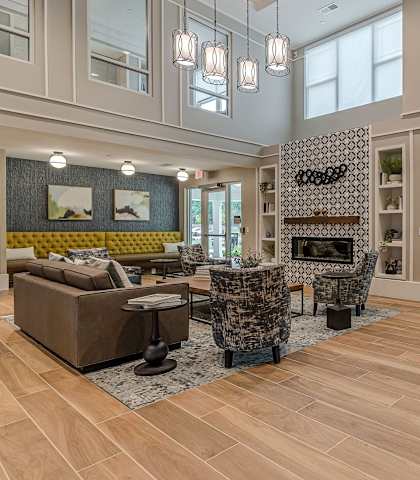 a living room with high ceilings and a fireplace